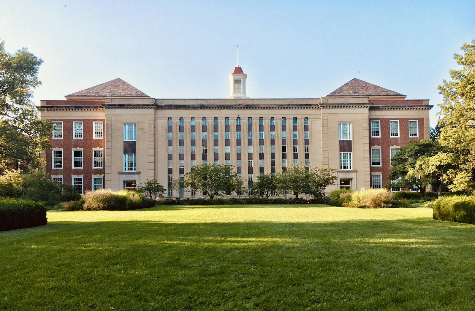 Brick campus building across a green lawn